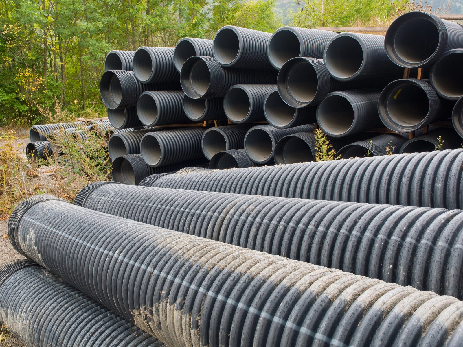 Large stacks of black culvert pipe